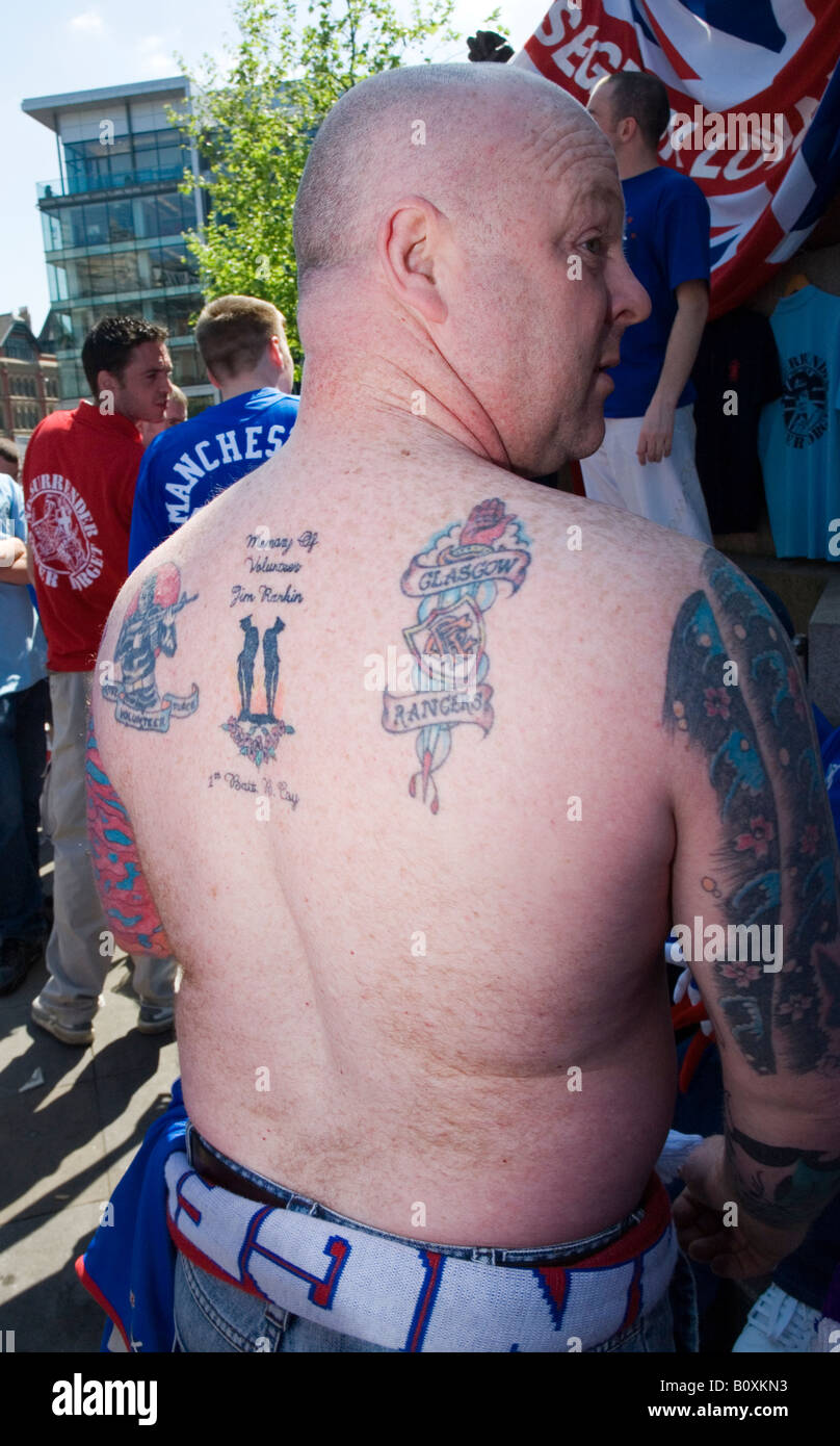 A Rangers fan displaying Rangers and UVF tatoos on his back Stock Photo