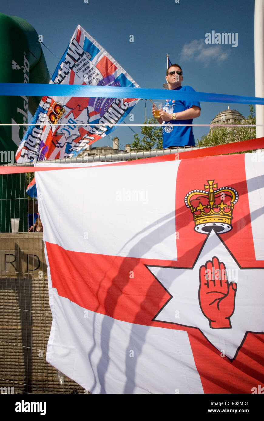 Glasgow Rangers fan with Union Jack flag standing behind an Ulster red hand flag, in Manchester UEFA Cup Final 14th May 2008 Stock Photo