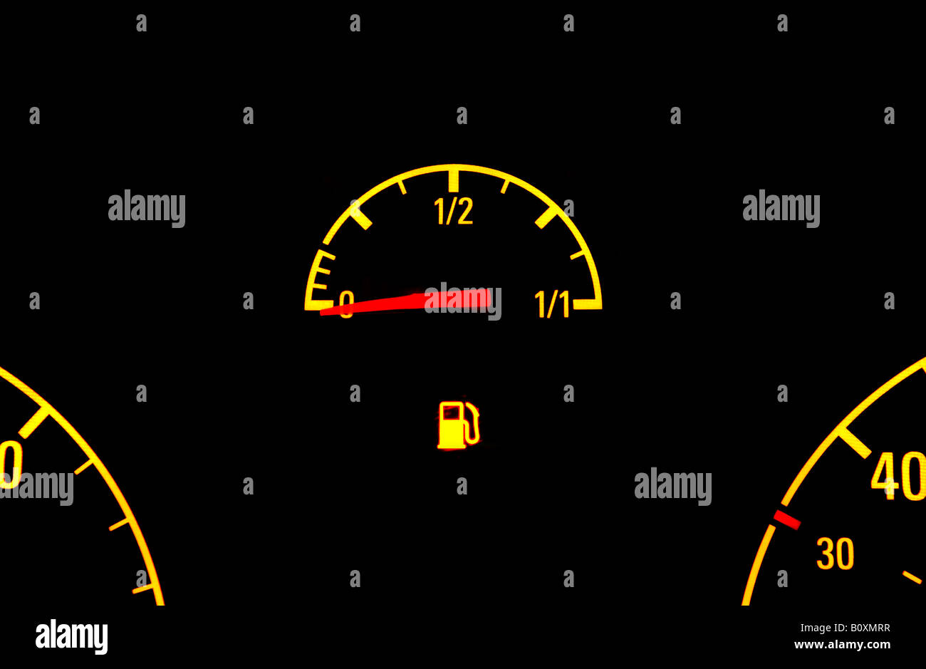 A BRITISH CAR FUEL GAUGE SHOWING LOW FUEL WITH  WARNING LIGHT,UK. Stock Photo