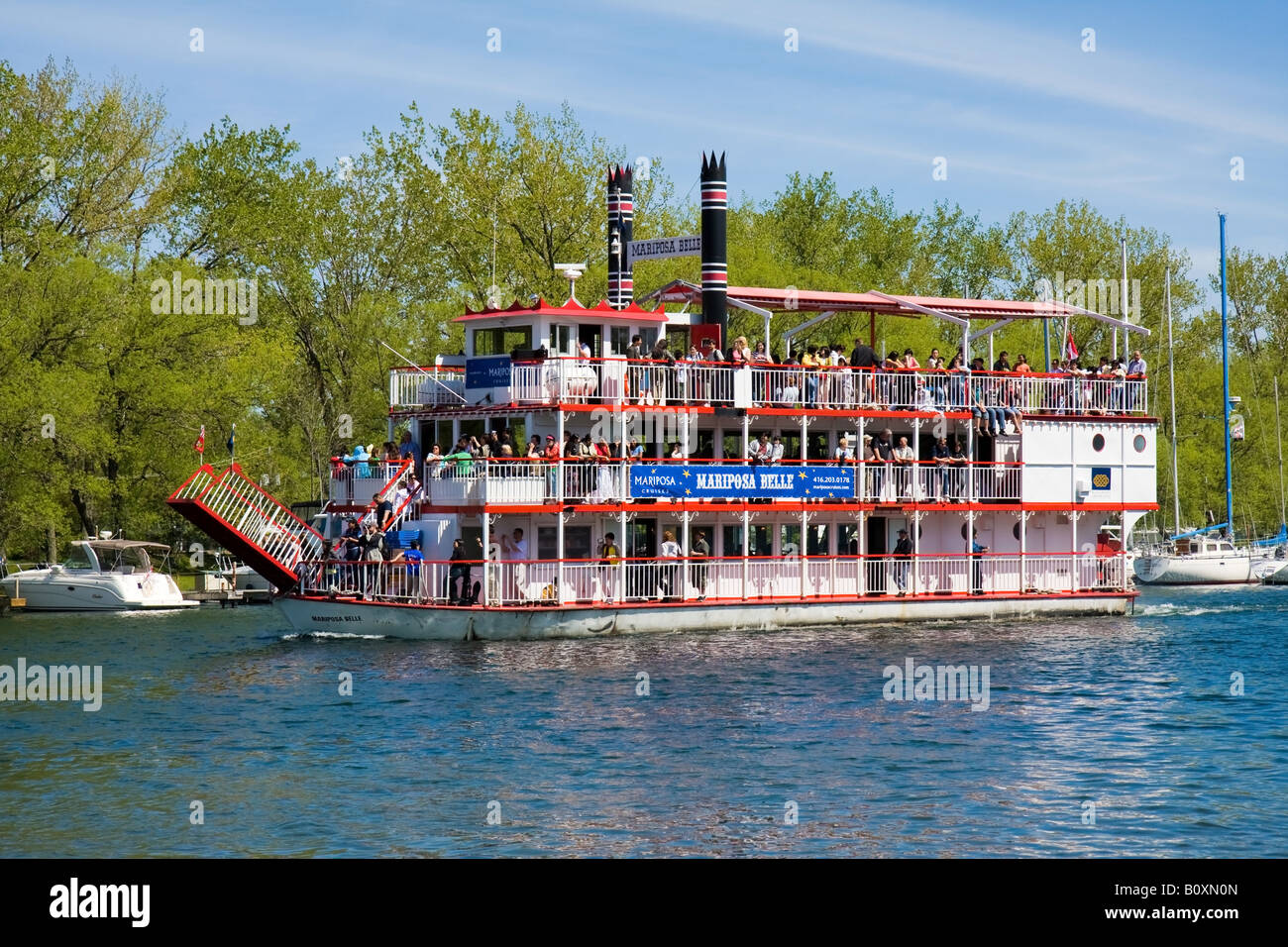 A tour paddle wheel boat going up the river. Stock Photo