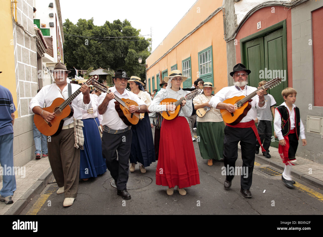 Folkloric group walking and playing various stringed instruments as part of the Romeria de San Isidro in Guia de Isora, Tenerife Stock Photo