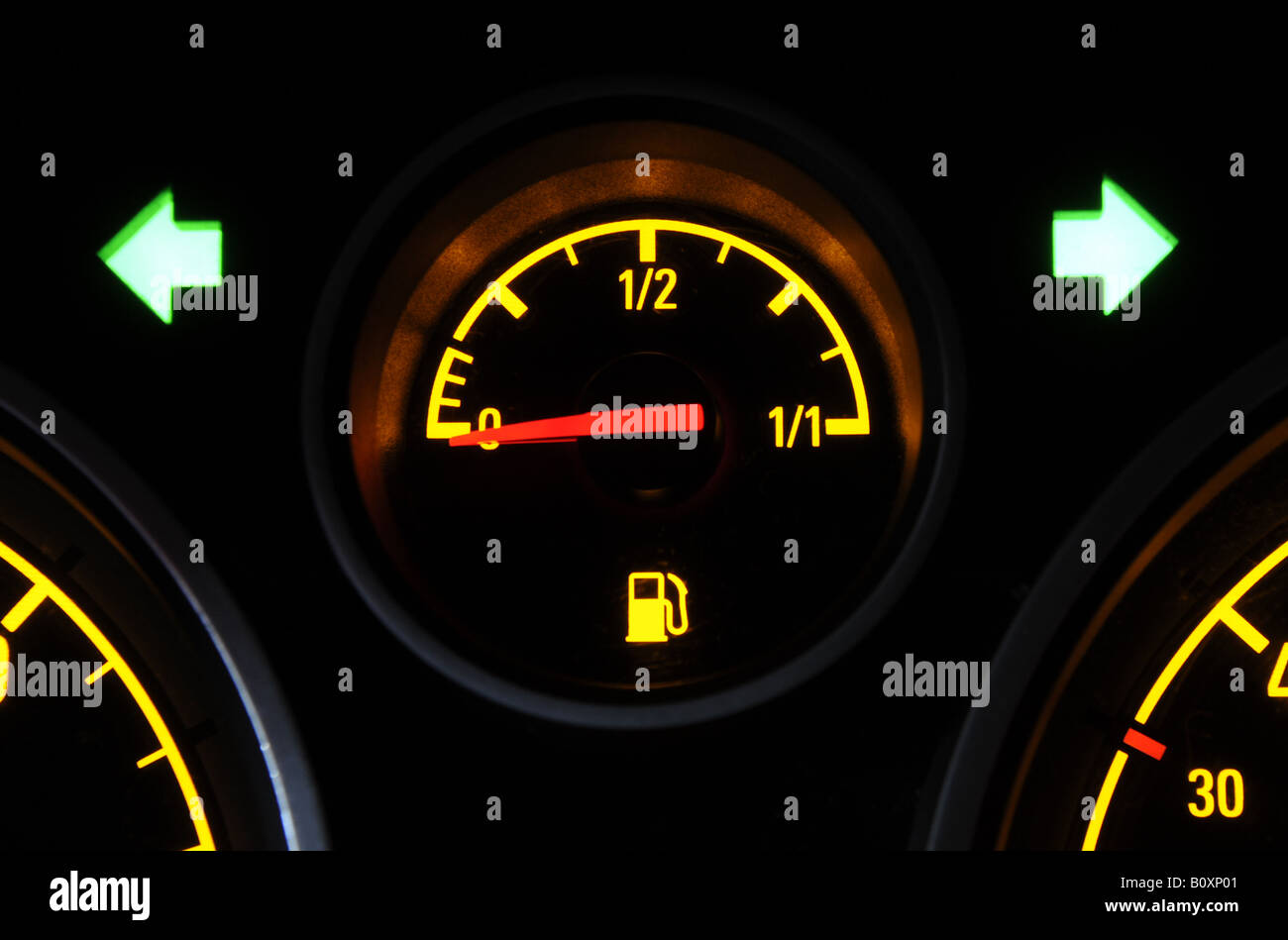 A BRITISH CAR FUEL GAUGE SHOWING LOW FUEL WITH FUEL WARNING LIGHT AND HAZARD FLASHERS,UK. Stock Photo