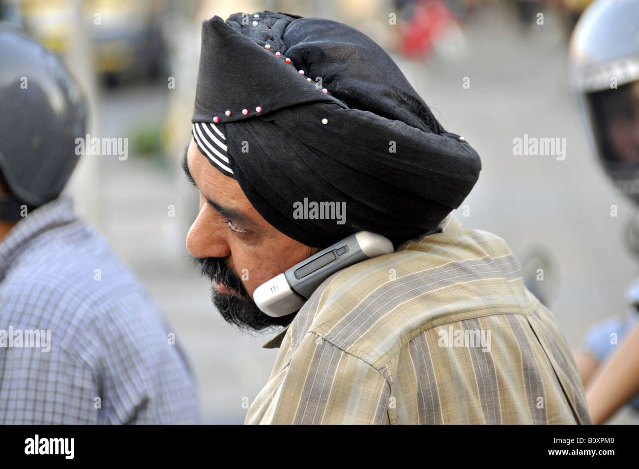 Sikh with mobile phone, Thailand, Bangkok Stock Photo