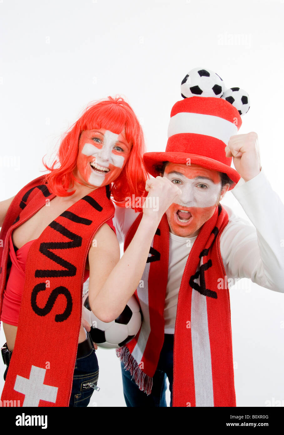 Austrian and Swiss soccer fans, EURO 2008. A man and a woman cheering with clenched fists Stock Photo