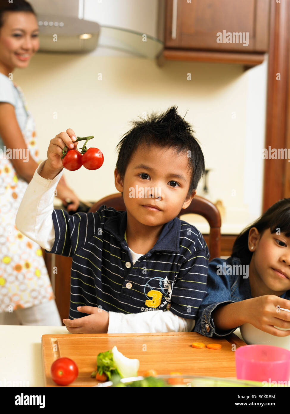 Child Helping In Kitchen children helping mother in the kitchen Stock Photo - Alamy