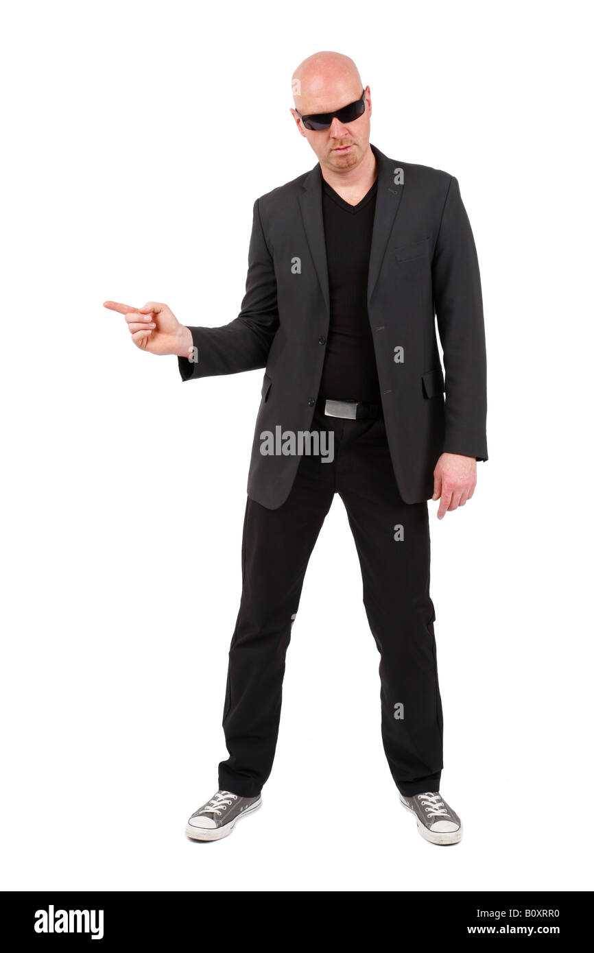 bald headed man pointing with his index finger to the side Stock Photo