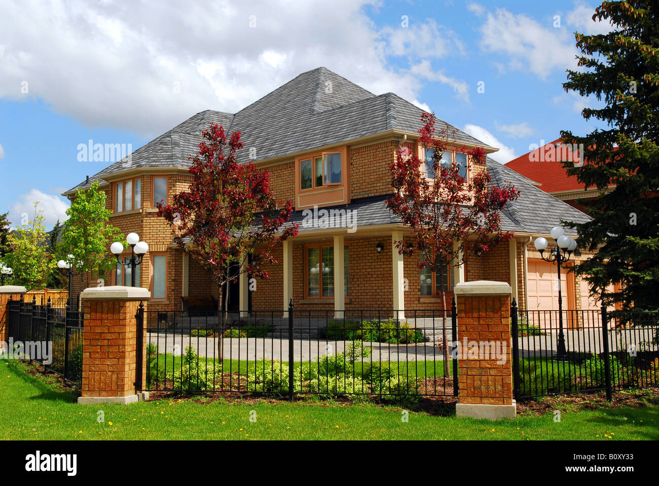 Big luxury residential house with iron fence Stock Photo