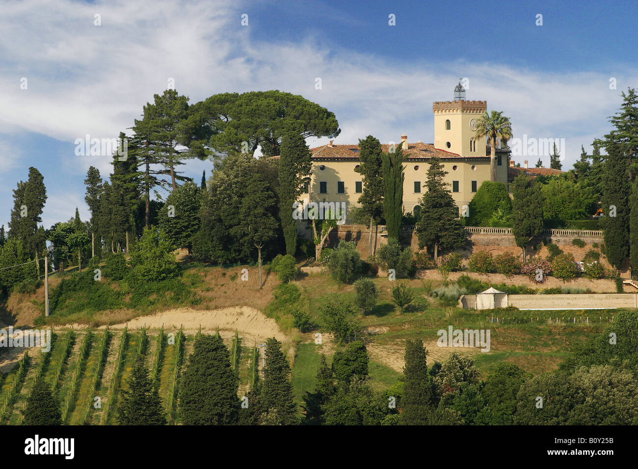 Tuscan landscape with traditional stone building in the distance Stock Photo
