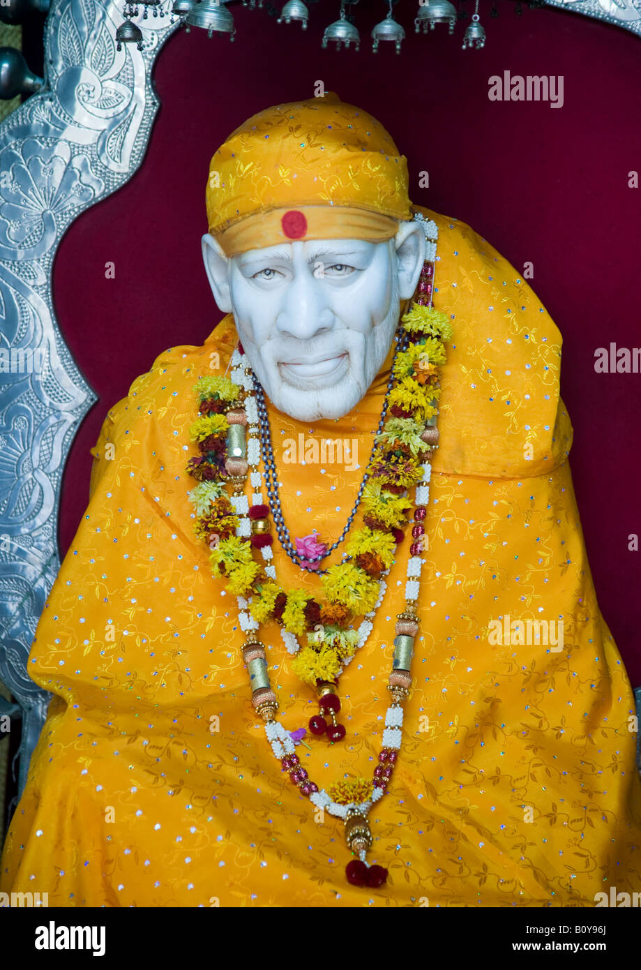 Portrait of the deity of Sai Baba of Shirdi at His temple in Dwarka where people come for pilgrimage to present their prayers. Stock Photo