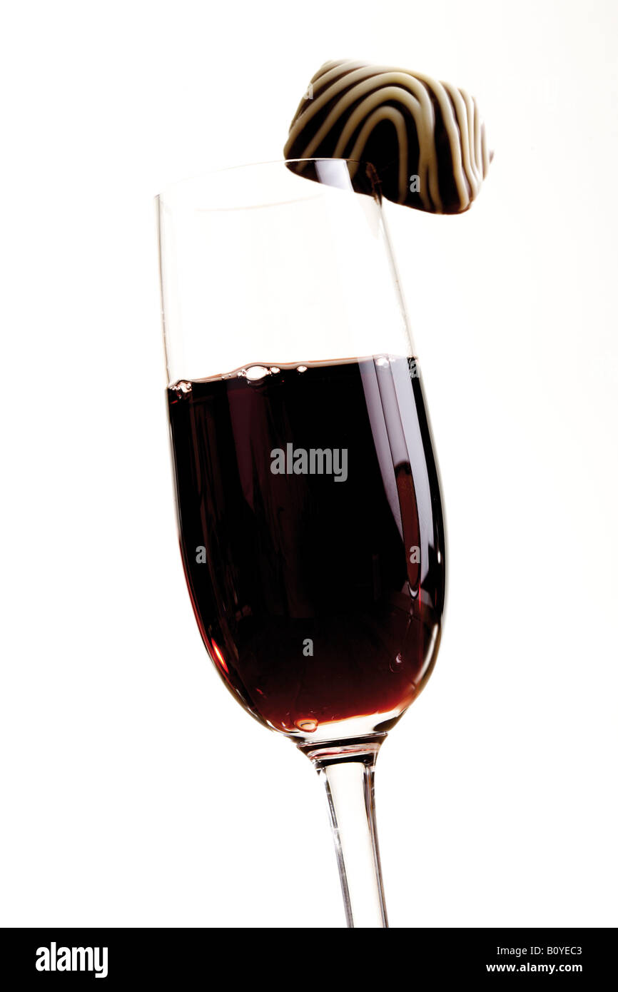Glass of port wine and a praline Stock Photo