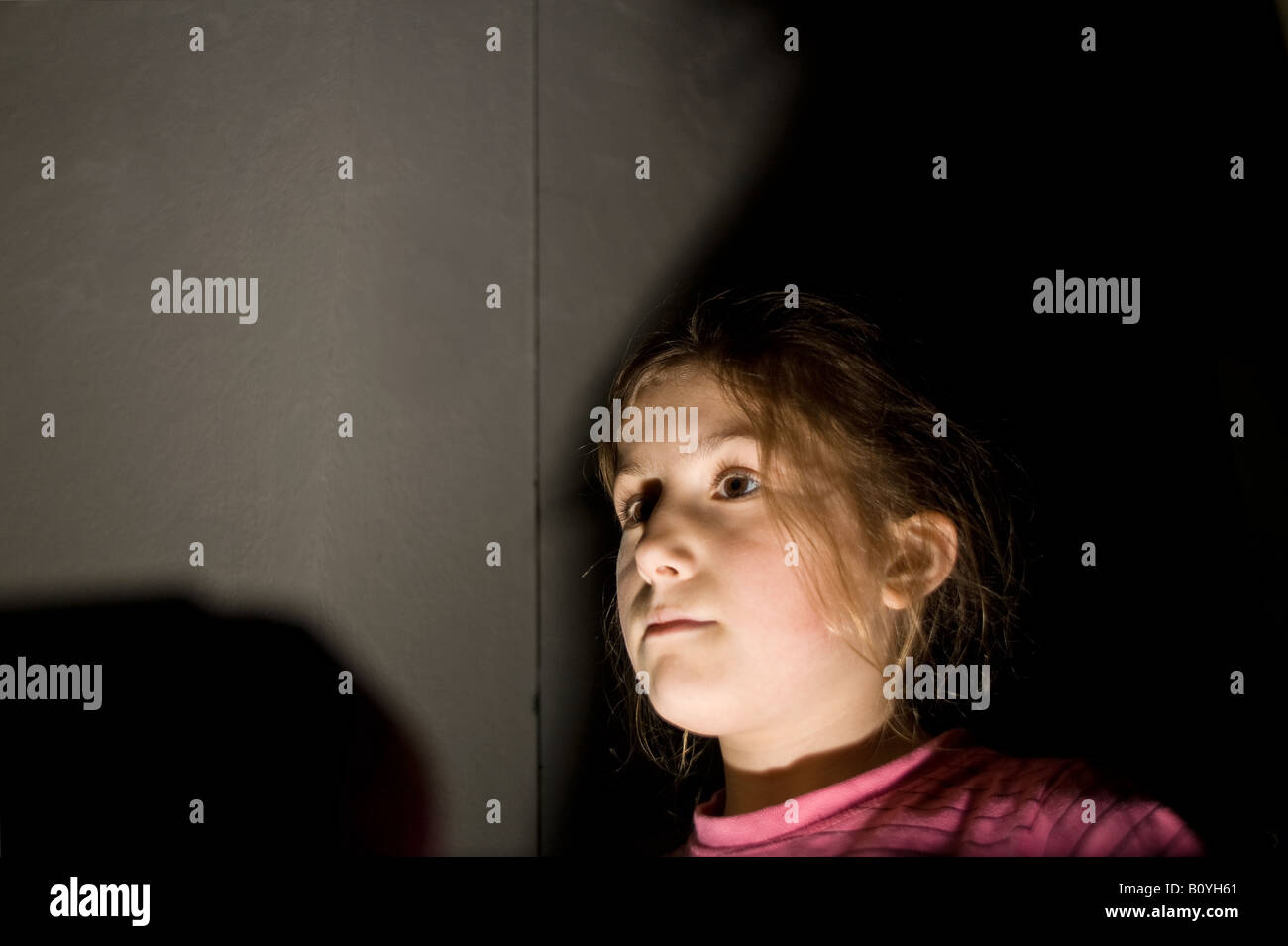 spooky picture of young girl in shadows Stock Photo
