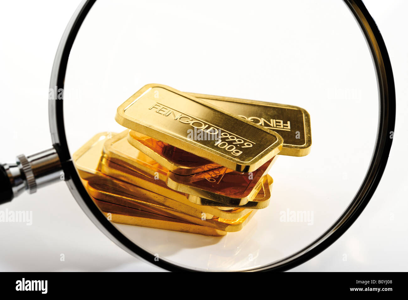Gold bars under magnifying glass, Stock Photo
