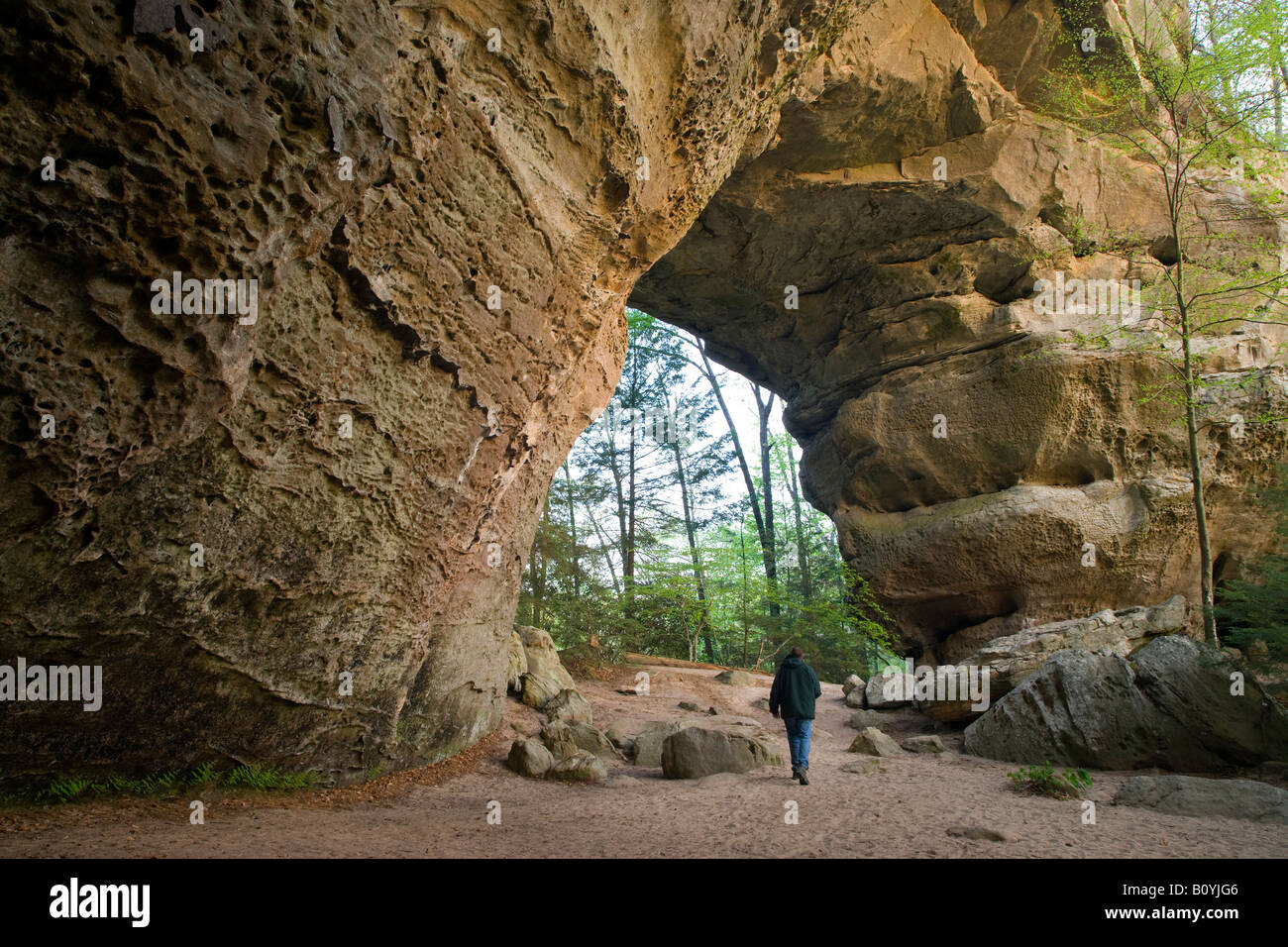 hiker under South Arch of the Twin Arches, Big South Fork National River and Recreation Area, Tennessee Stock Photo