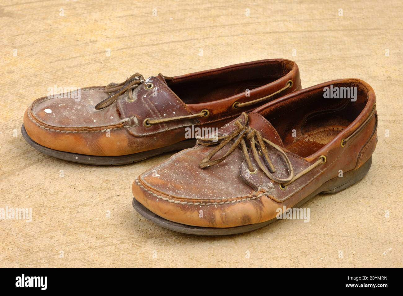 Old shoes on the workshop floor Stock Photo