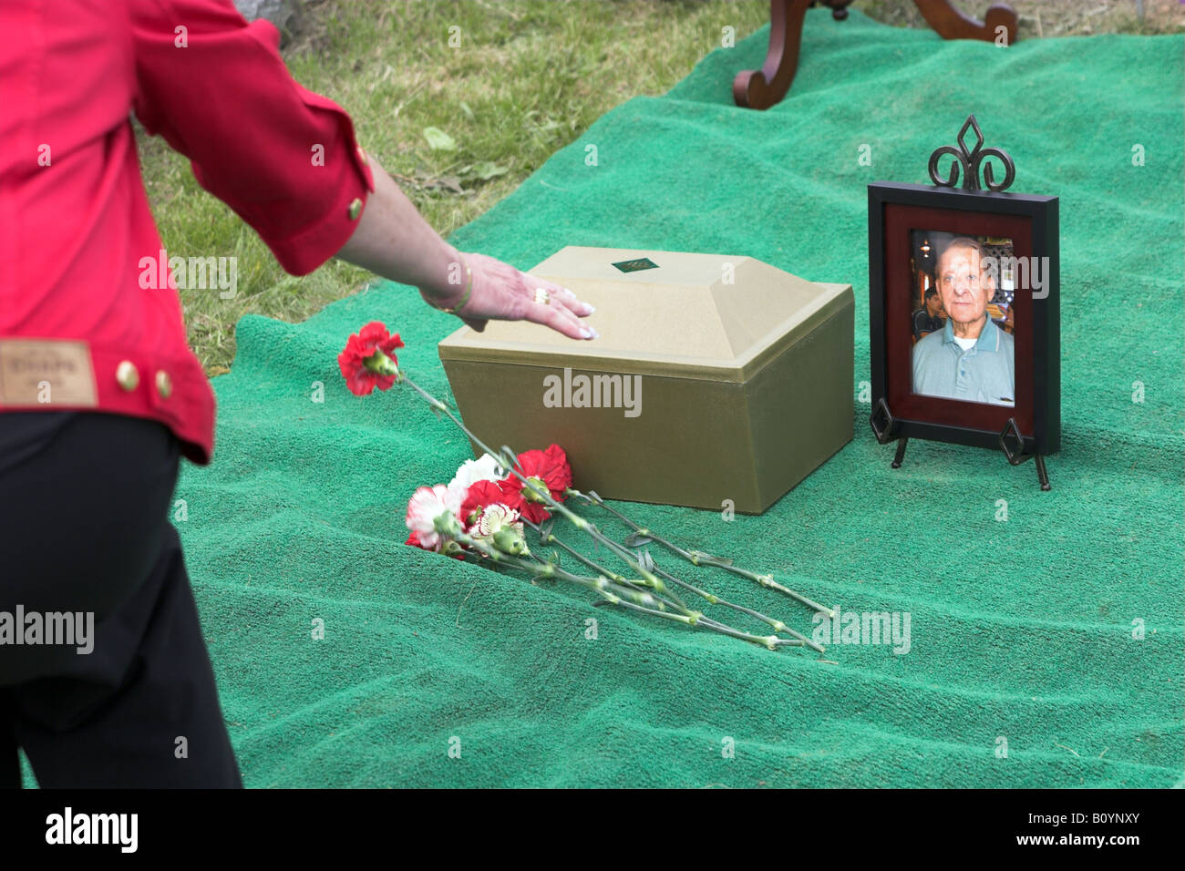 Woman leaving a flower at a grave site of a loved one Stock Photo Alamy