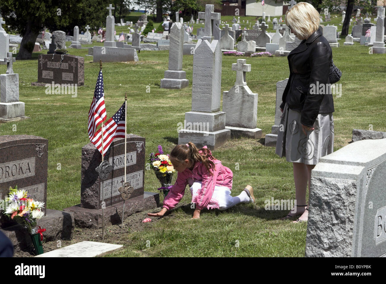 Mom and daughter visit the grave of a loved one Stock Photo Alamy
