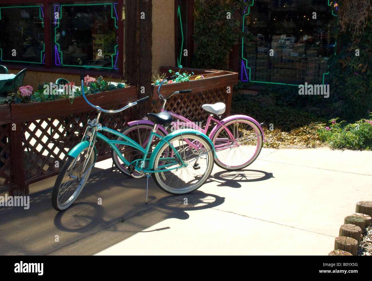 Two bicycles wait outside store in sun, USA Stock Photo Alamy