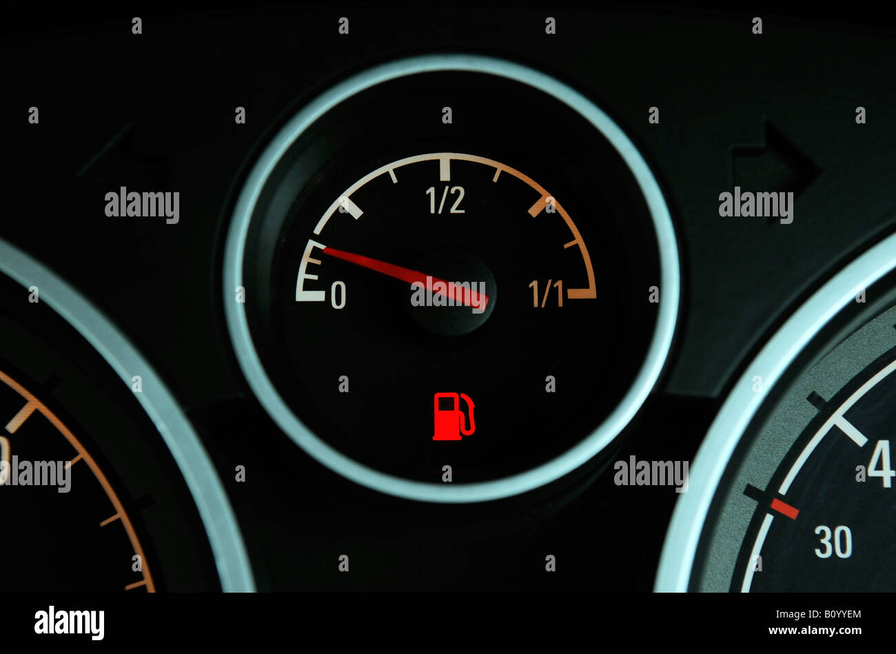 A BRITISH CAR FUEL GAUGE SHOWING LOW FUEL WITH RED WARNING LIGHT,UK. Stock Photo