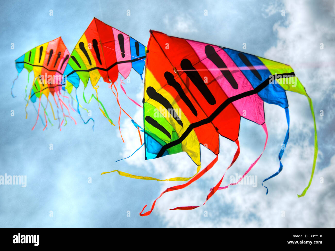 Static line kites flying against a blue and cloudy sky Stock Photo Alamy