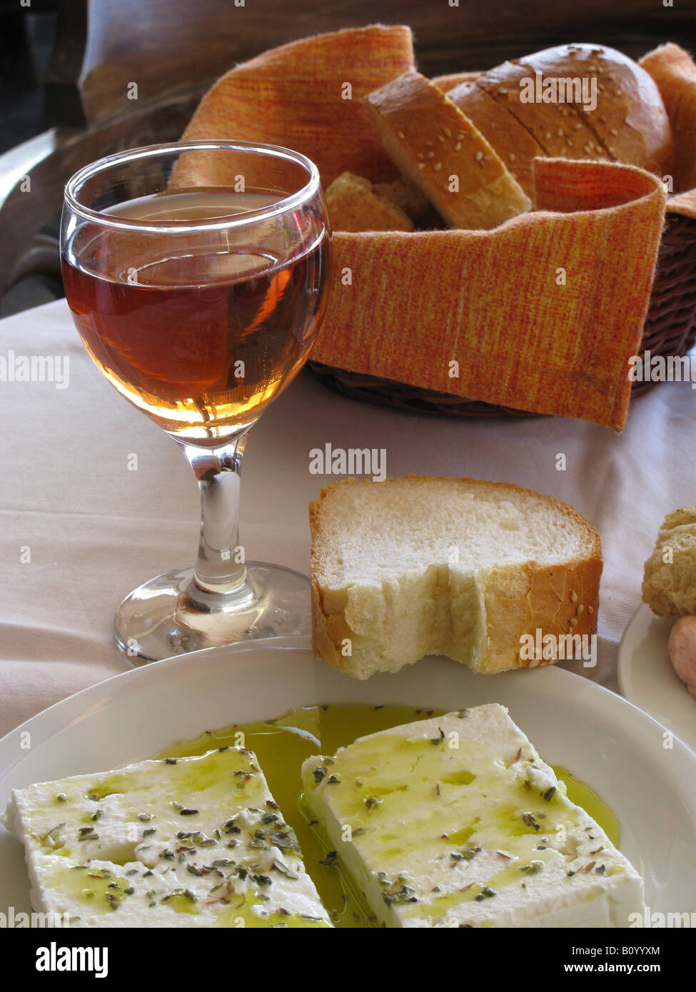 Greek Cuisine Feta cheese in Olive Oil and a glass of red wine Chania Crete Greece Stock Photo