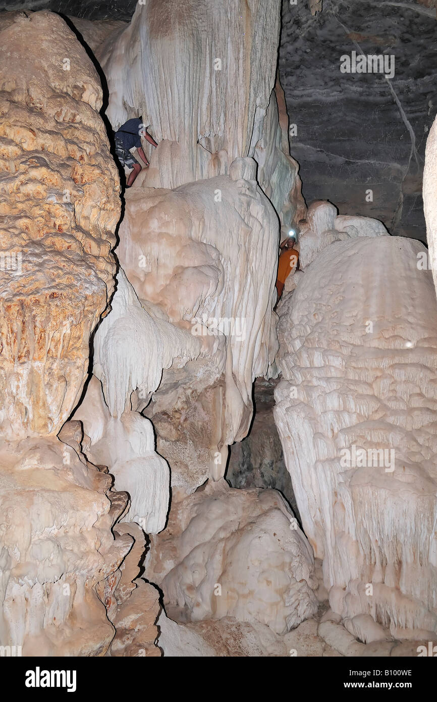 Cave climbing with buddhist monk in Thailand, Kanchanaburi province. Stock Photo