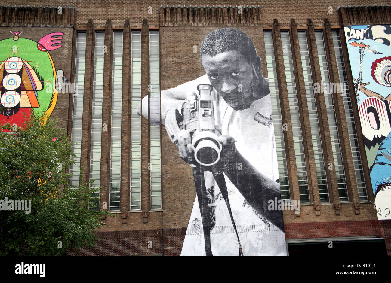 Giant street art figures on walls of Tate Modern in London Stock Photo