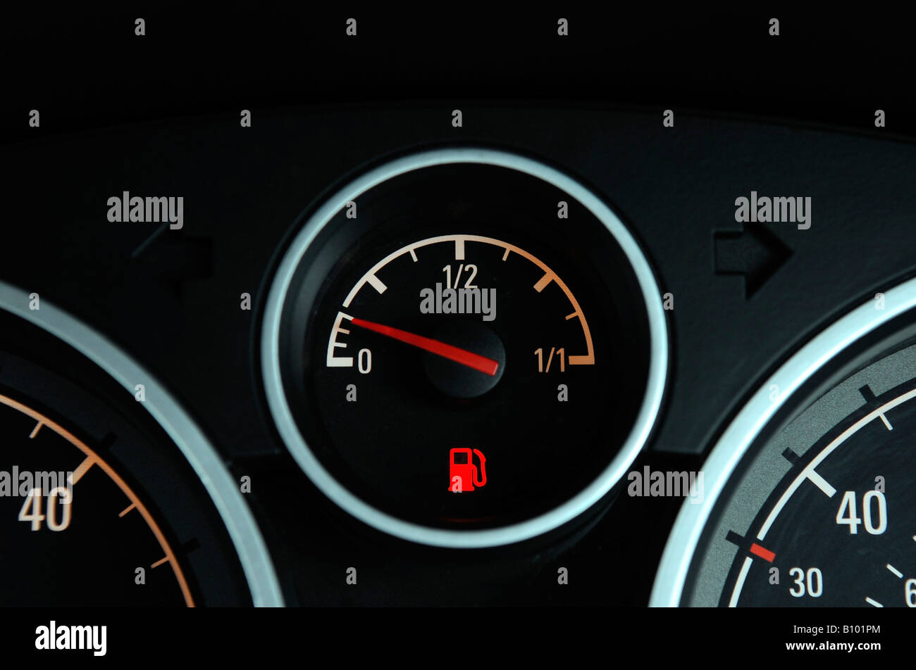 A BRITISH CAR FUEL GAUGE SHOWING LOW FUEL WITH RED WARNING LIGHT,UK. Stock Photo