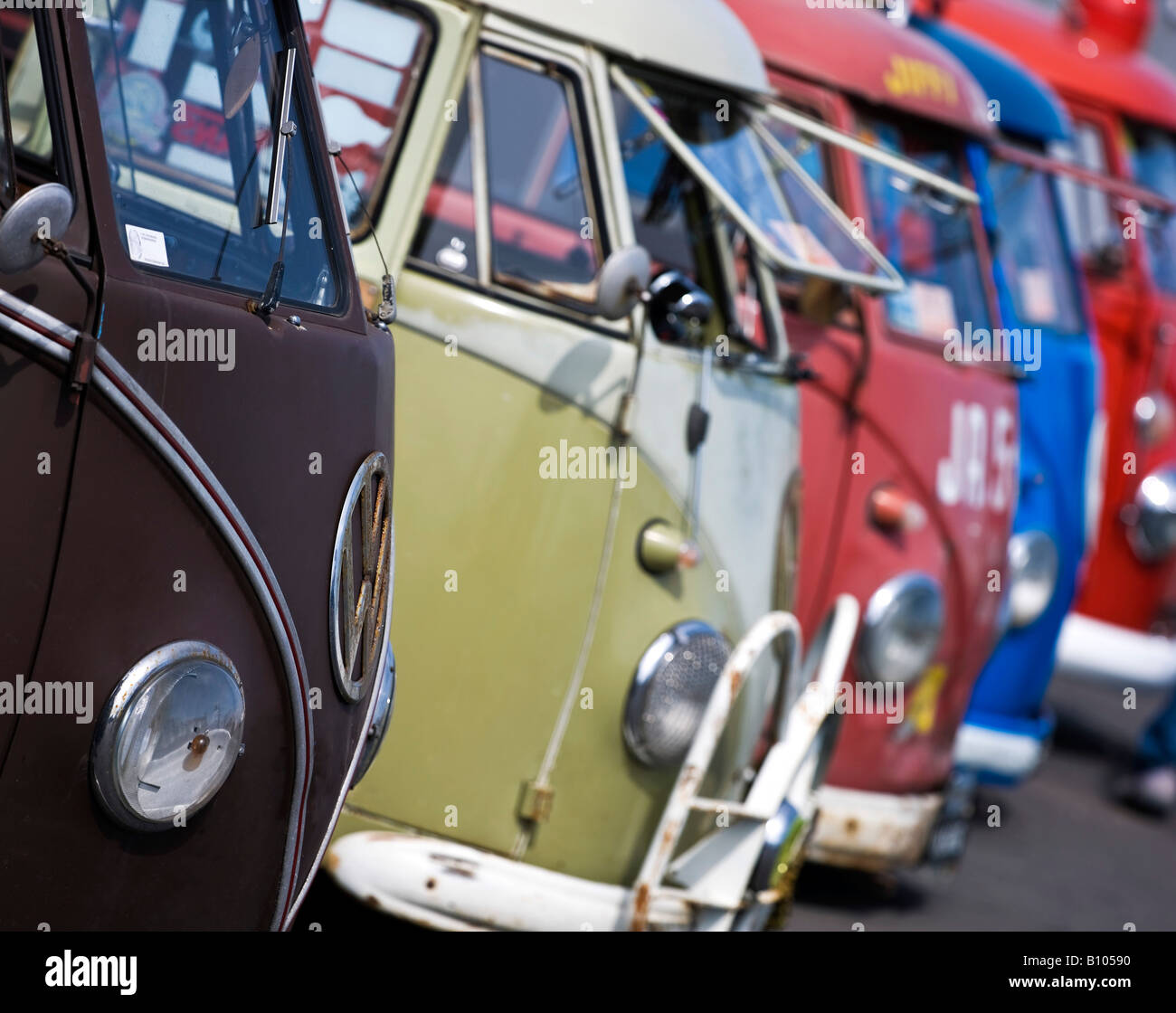 colorful line up of vw volkswagen split screen bus camper vans Stock Photo