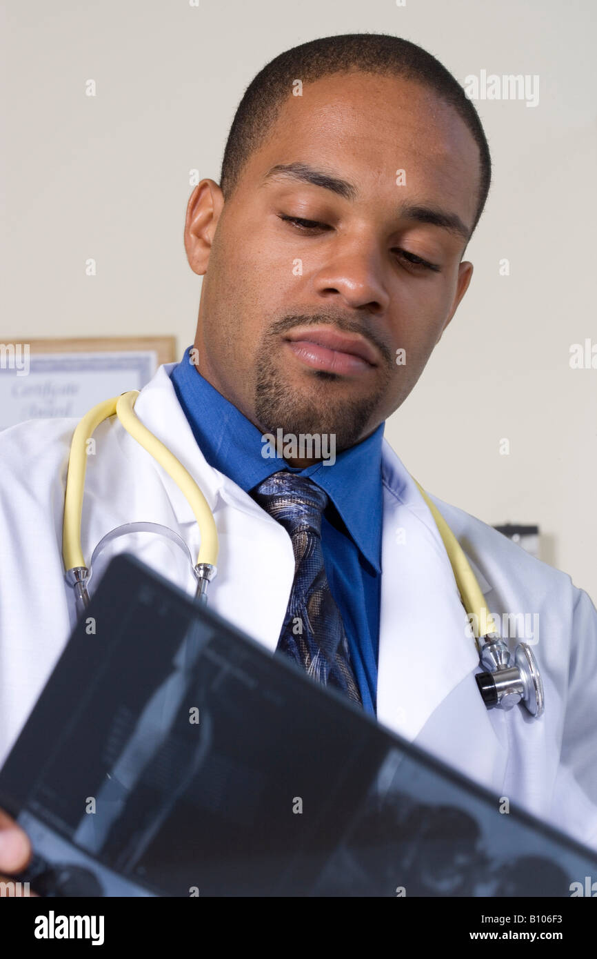 Doctor reviews patient's xrays and records Stock Photo Alamy