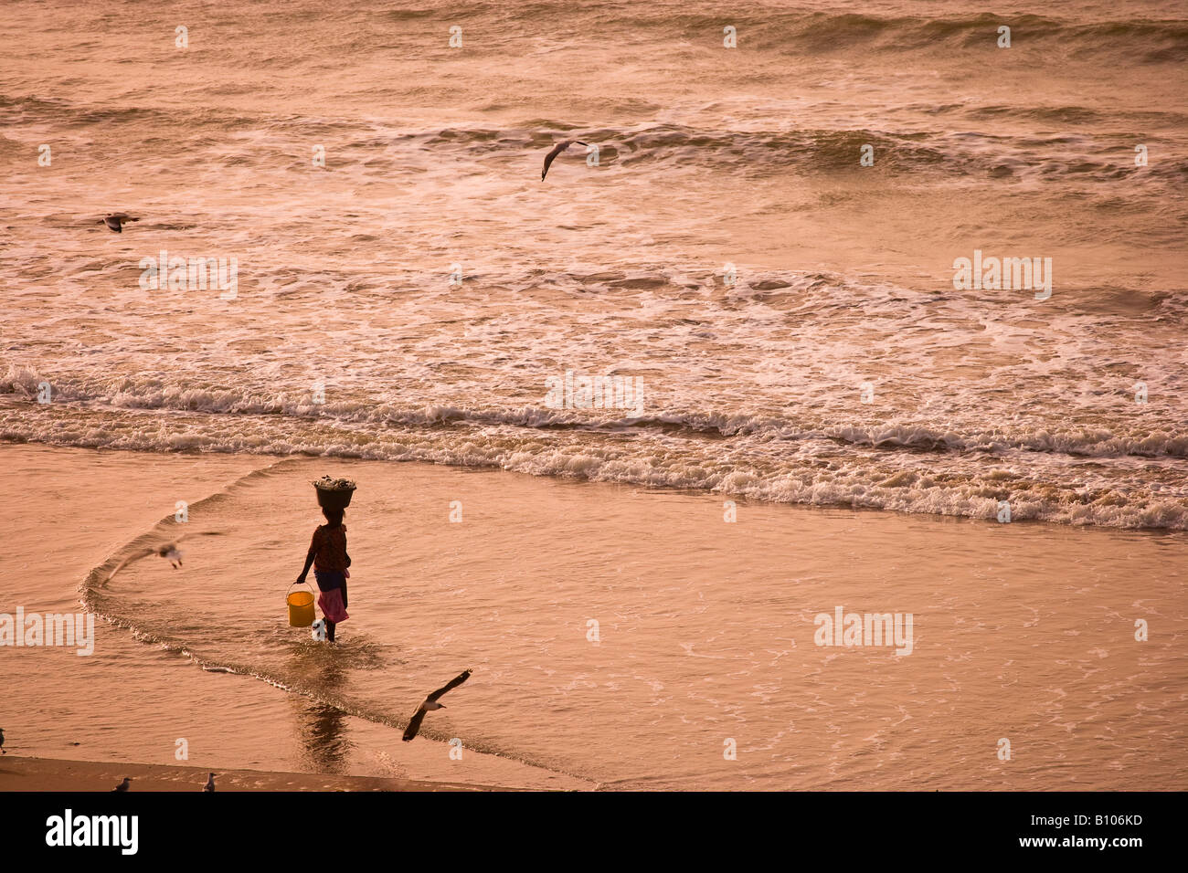 Local woman walking on beach, Bakau, Gambia, west  Africa Stock Photo