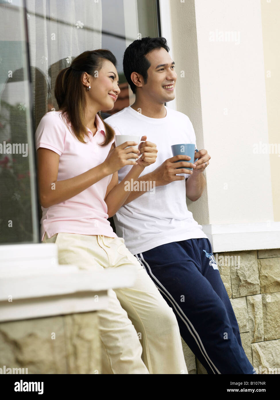 A young couple relaxing outside Stock Photo