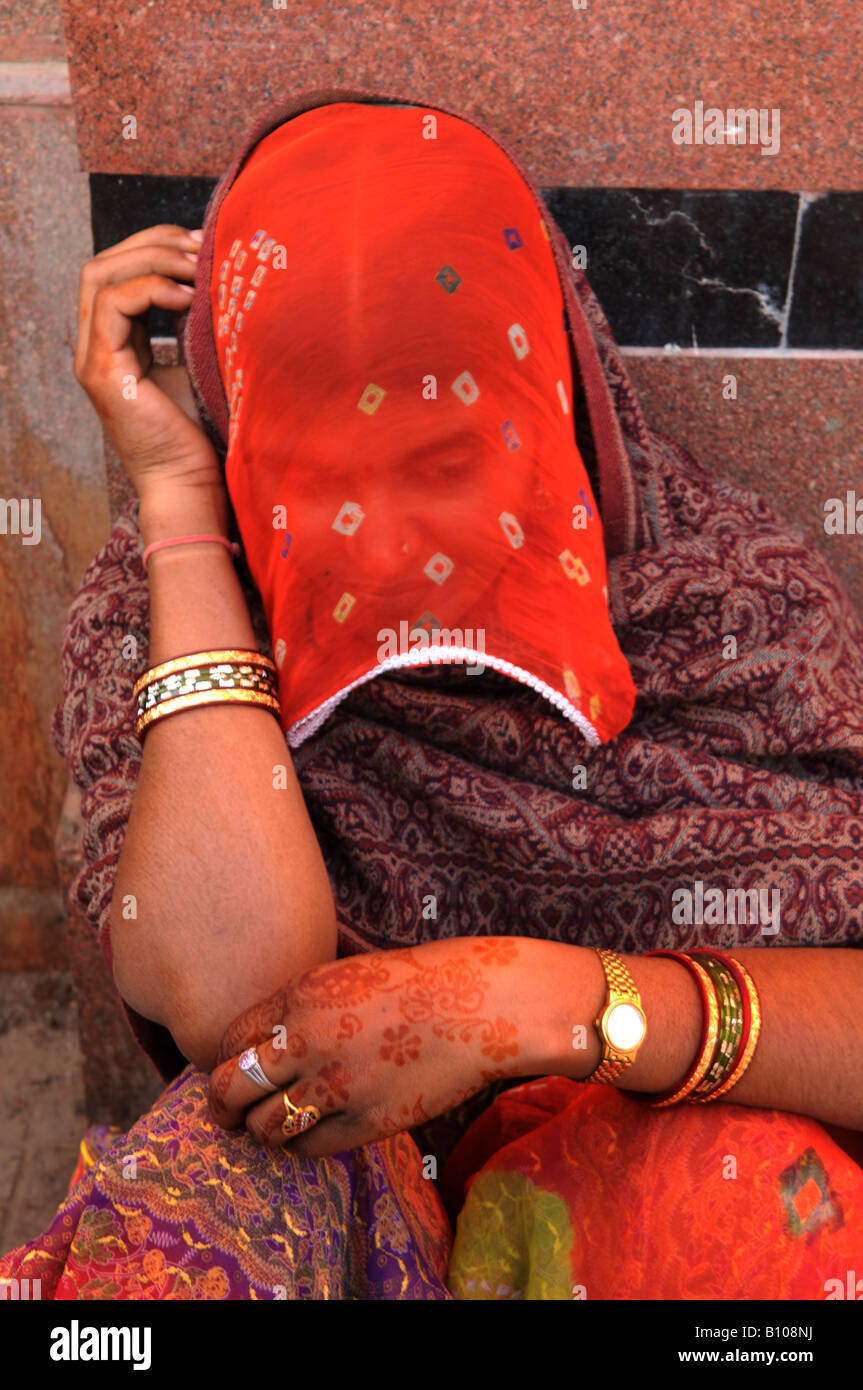 A beautiful Rajasthani woman hides behind her red veil Stock Photo - Alamy