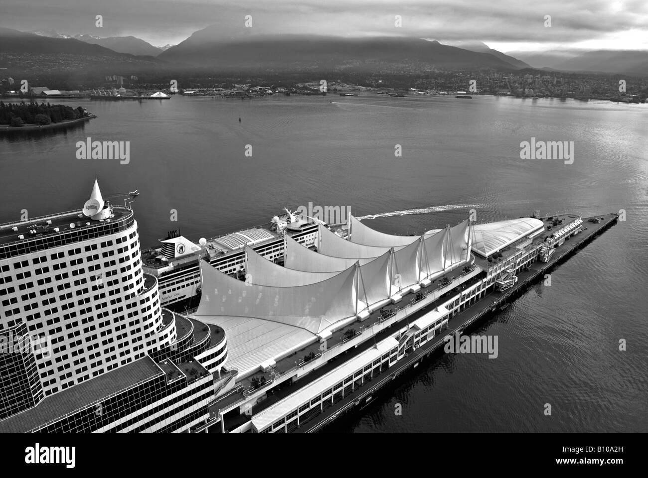 Aerial view of an Alaskan cruise ship docking at Canada Place cruise ship terminal and Vancouver Trade and Convention Centre. Stock Photo