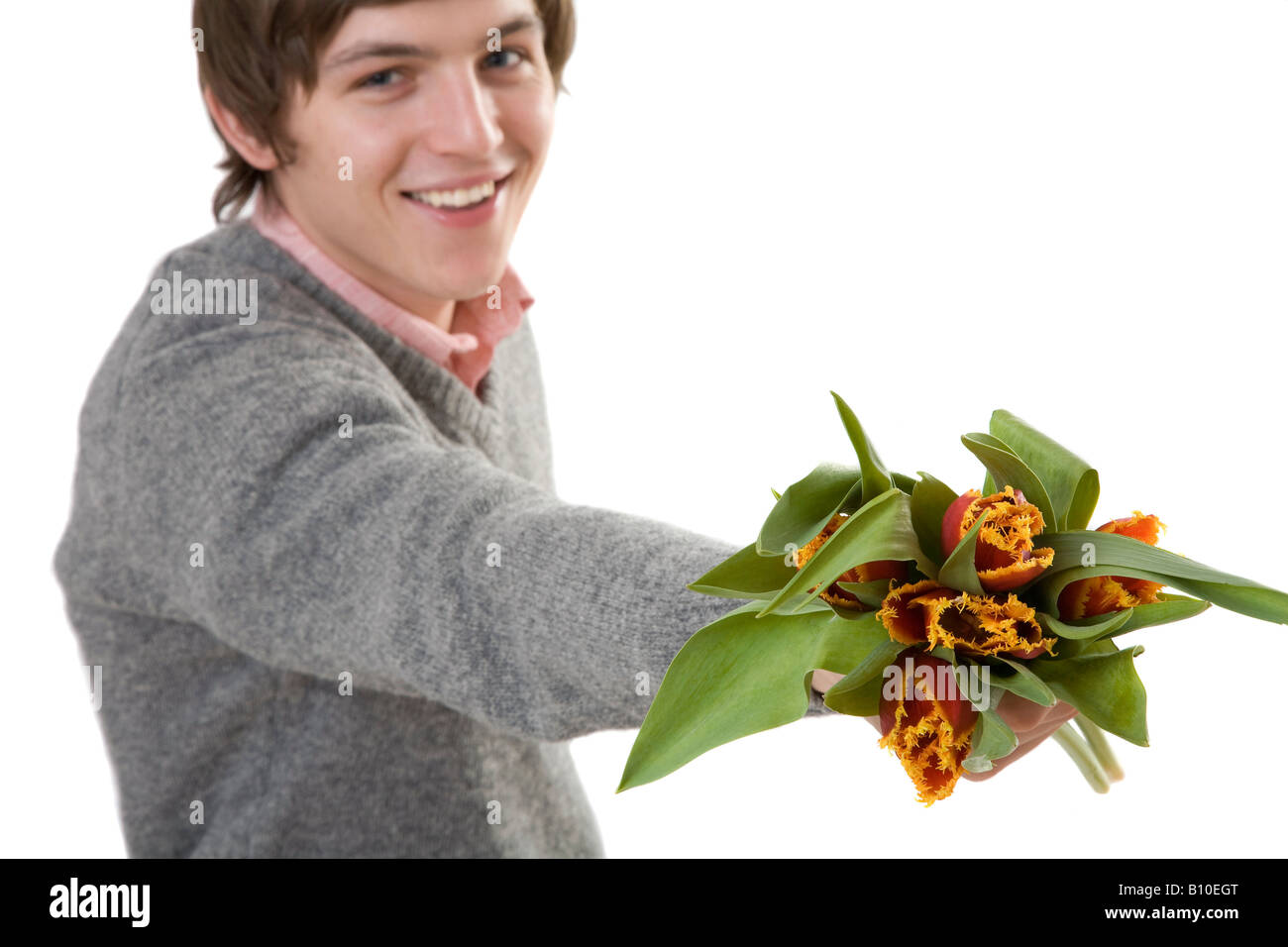 Young man offering flowers Stock Photo Alamy