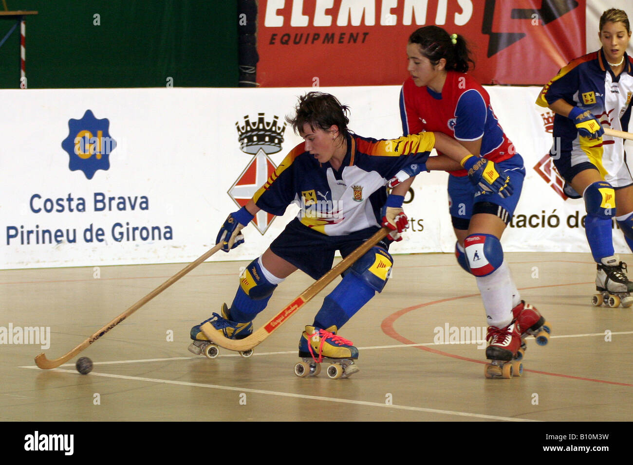 Two female roller hockey players fight for the ball Stock Photo - Alamy