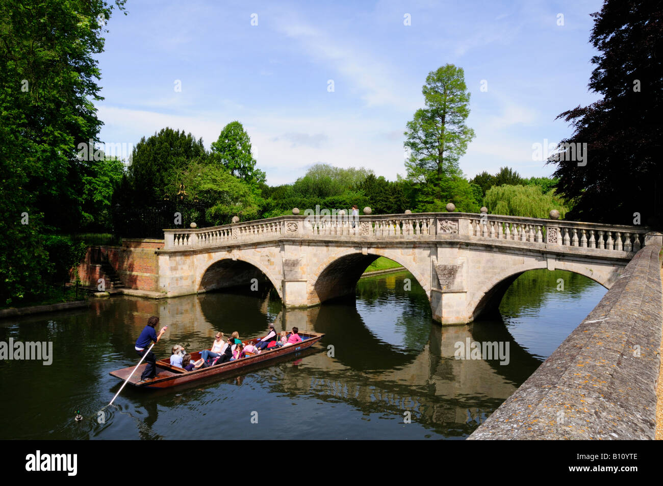 Tourists punting at Clare Bridge Cambridge England UK Stock Photo