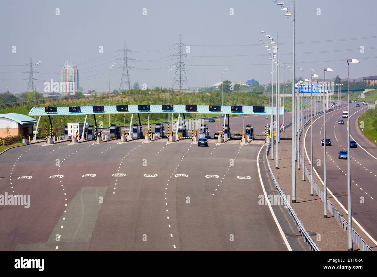 M6 TOLL MOTORWAY from above with vehicles approaching toll booths West