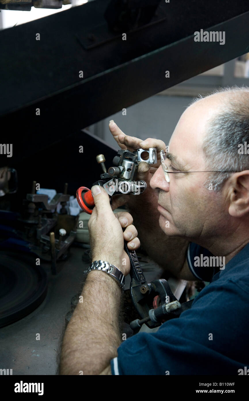 diamond cutting and polishing worker inspecting the diamond