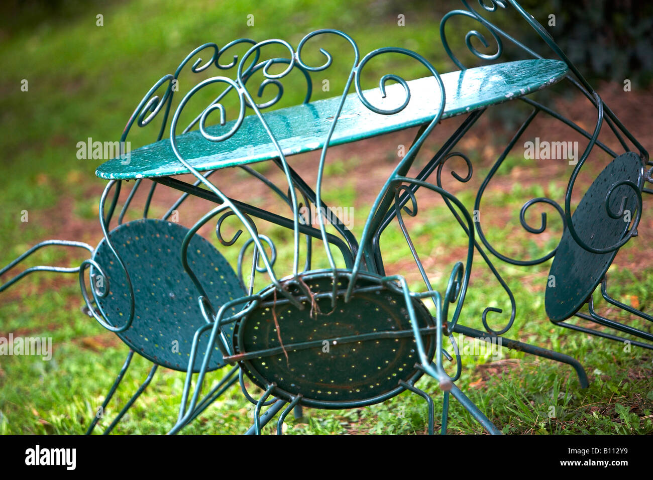 Green Metal Garden Furniture In A Rustic French Setting A Wet Day