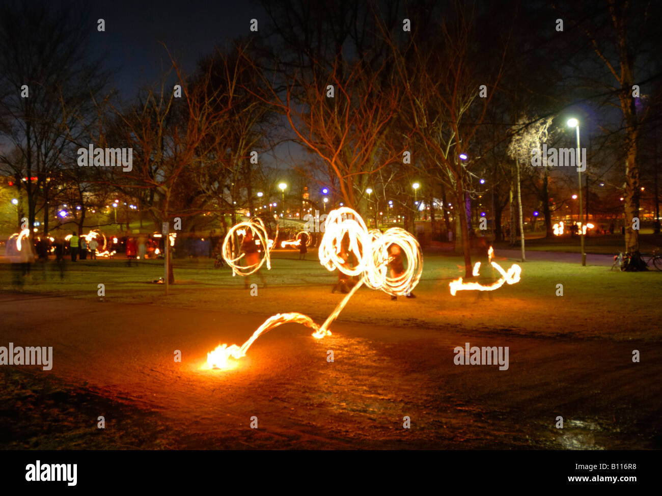 The nighttime firedancers in the Kaisaniemi park, Helsinki, Finland, Europe. 'Oops, a flying torch!' Stock Photo