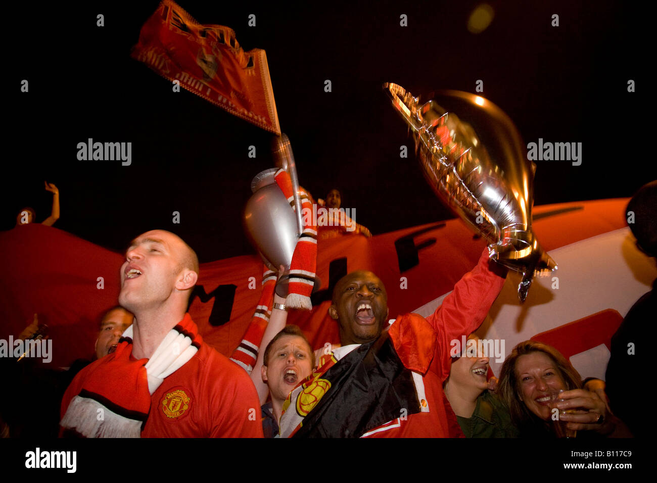 MANCHESTER MAY 21, 2008 Manchester United fans celebrate outside Old Trafford after their team won the UEFA Champions League. Stock Photo