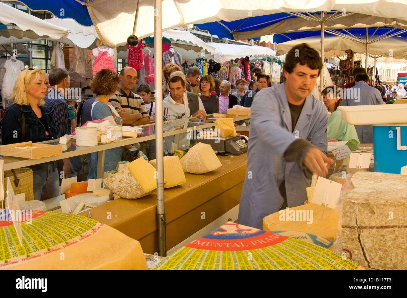 Busy cheese stall in the Sunday market of Moissac, south west France. Bargain prices Stock Photo