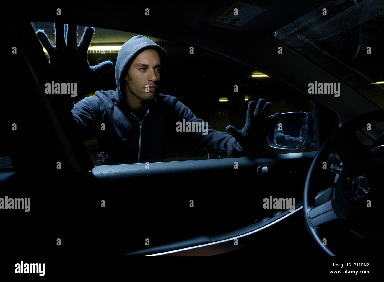 Thief Looking To Break Into Car Window Stock Photo Alamy