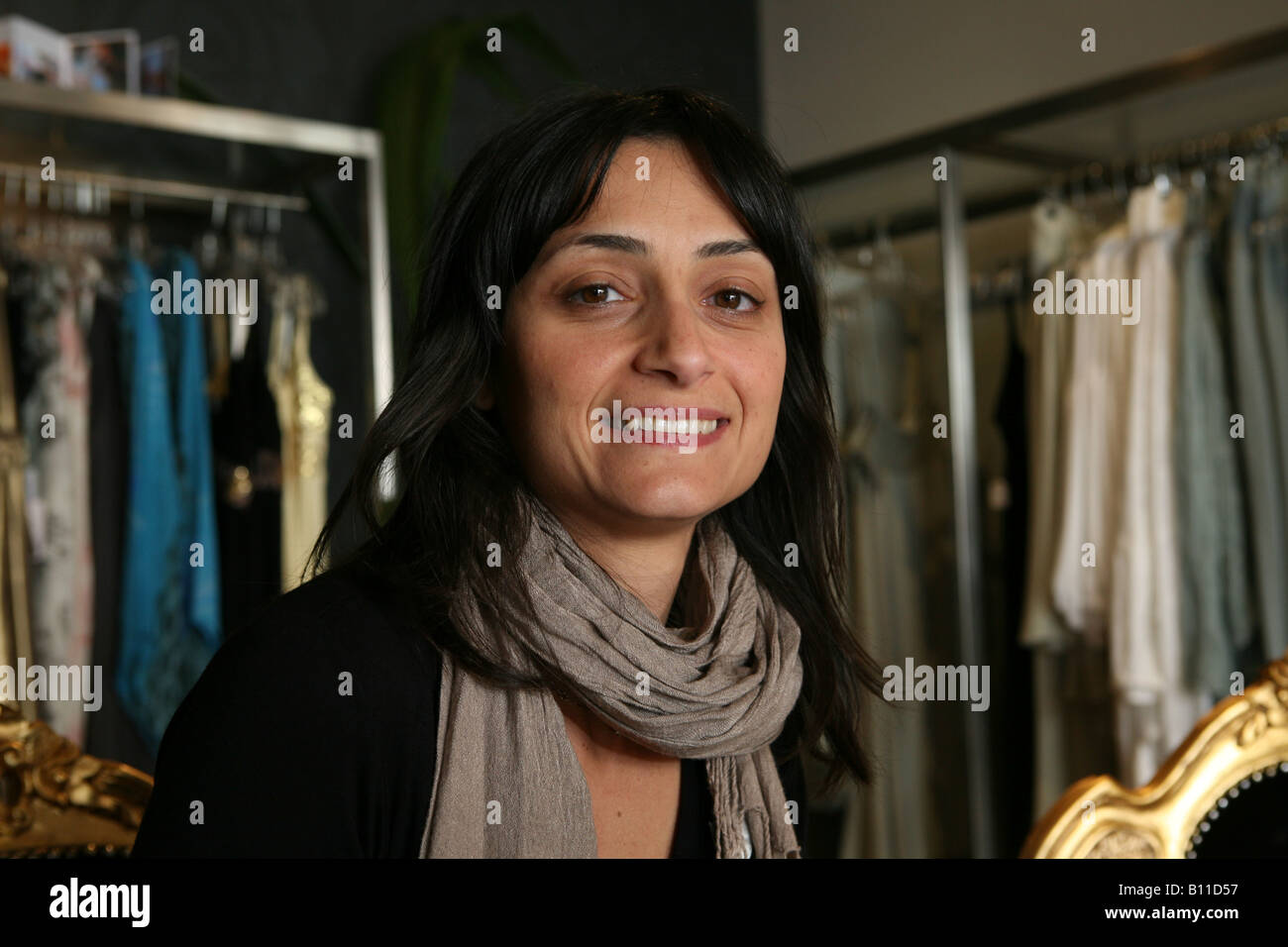 a portrait of a beutiful middle aged woman in a stylish clothing shop