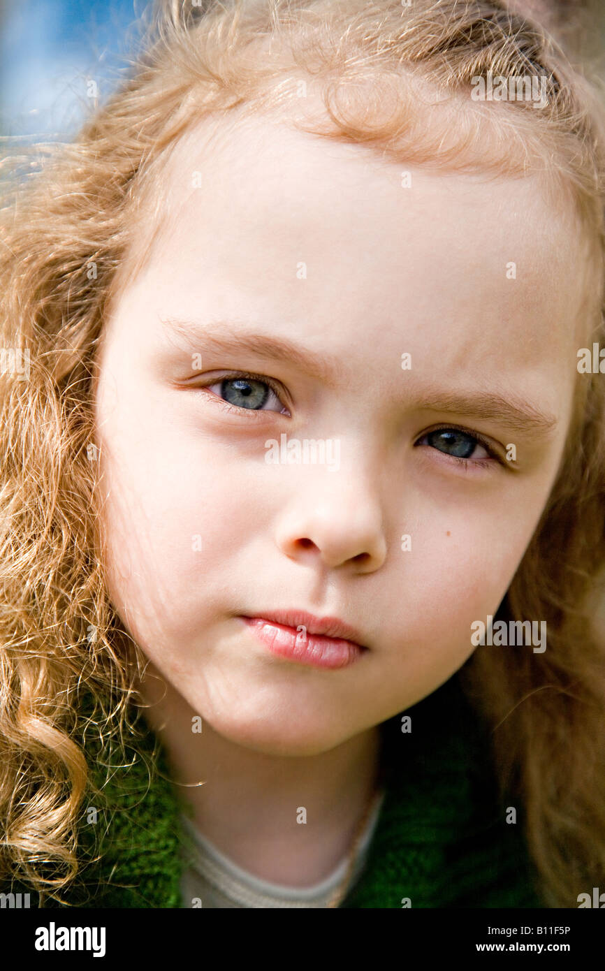 The beautiful little girl in a pink cap embraces mum with light hair