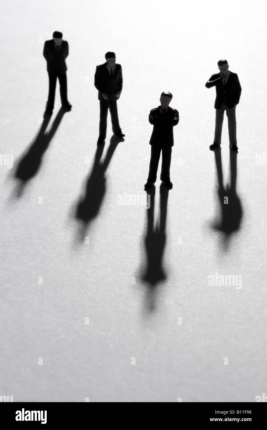 Businessmen in silhouette, backlit with shadows Stock Photo