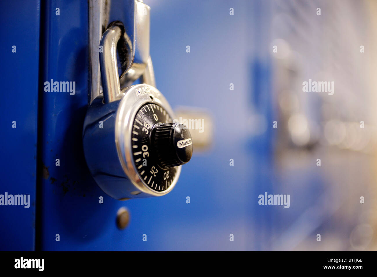 a Master Lock on a blue gym locker Stock Photo