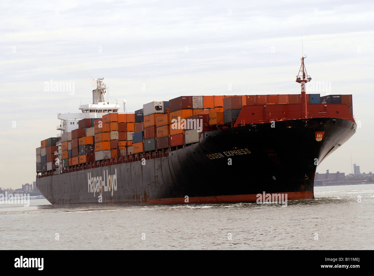 The Essen Express of the Hapag Lloyd line leaves port on the Hudson River North River in New Jersey laden with containers Stock Photo