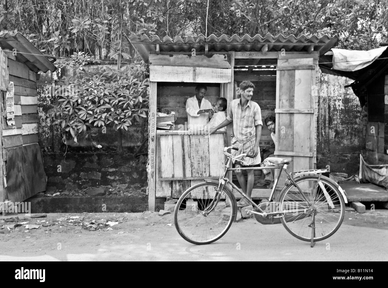 INDIA KERALA KOCHI Tiny barber shop in a shack on a dirt street in the city of Kochi Stock Photo