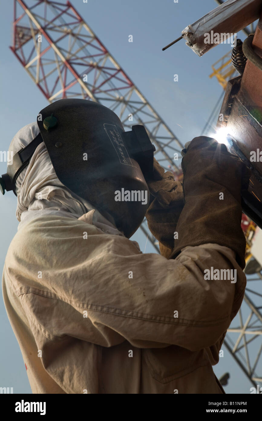 Welder welding on oil platform Port Khalid Sharjah United Arab Emirates